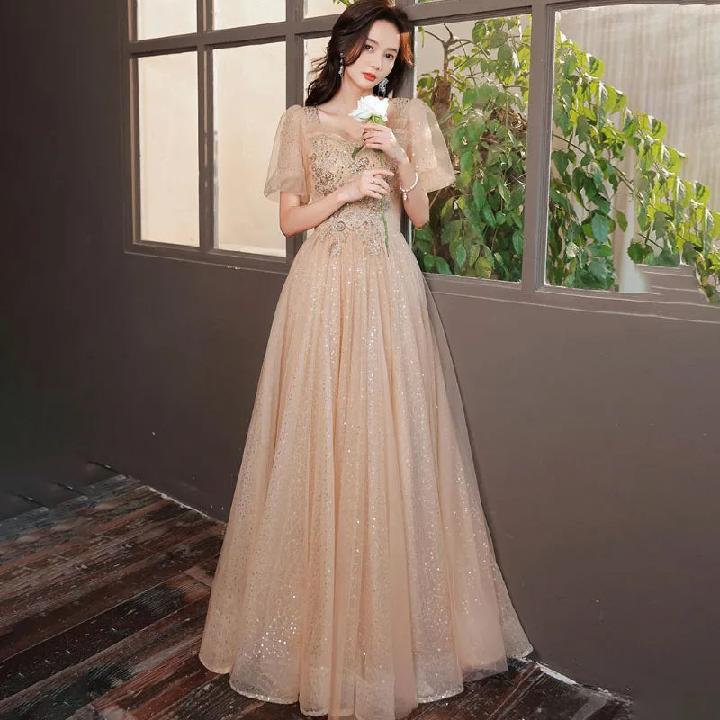 Glittering Champagne Gown with Embellished Bodice Design